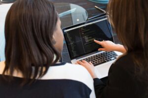 People working on digital adoption on a laptop